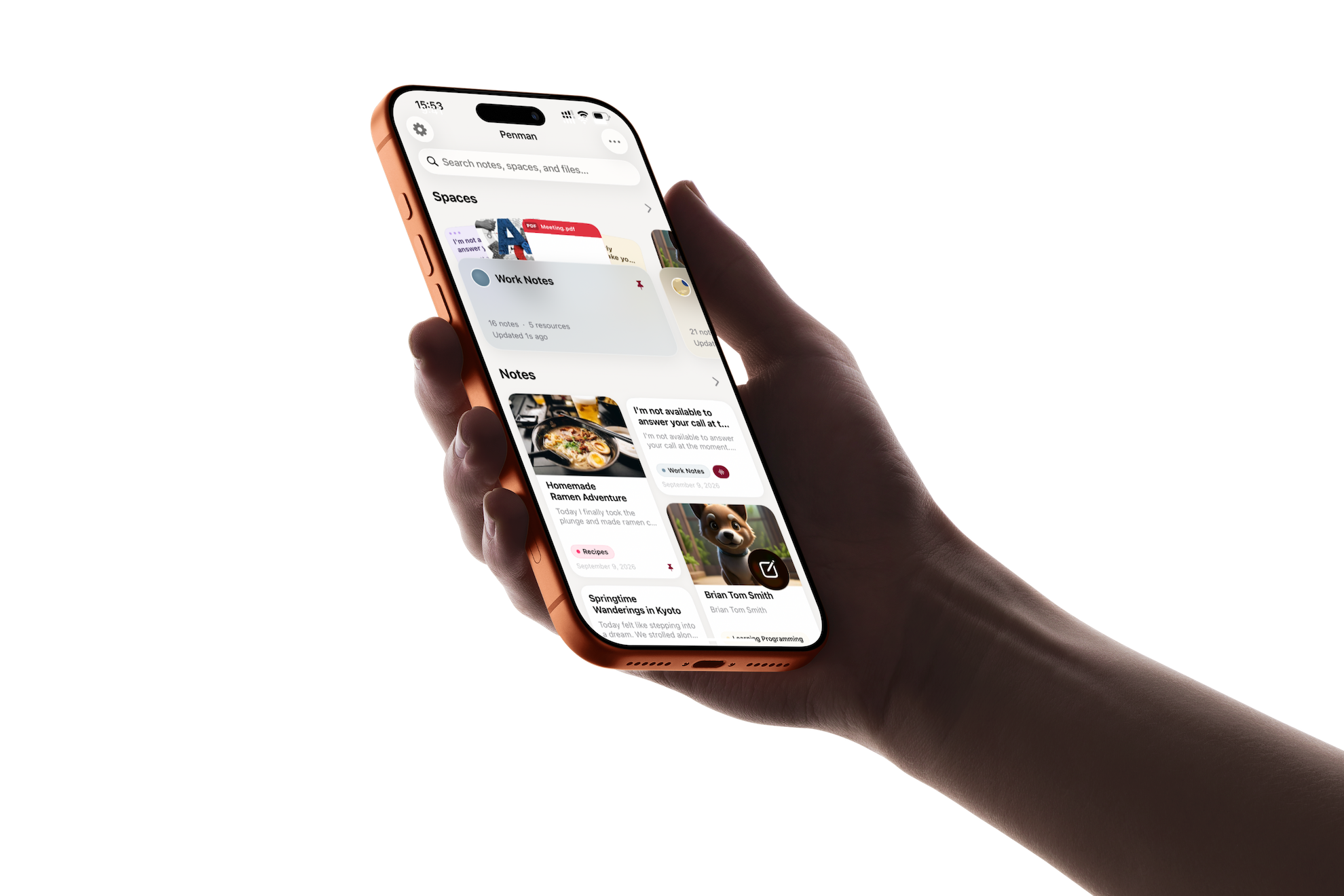 Hand holding an iPhone showing the Penman app — notes and Spaces on the home screen